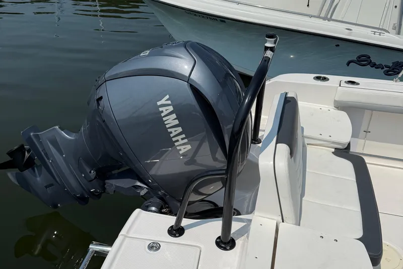 Slide: The Image of 2023 Robalo R207 Dual Console with Yamaha outboard engine on water. - 5