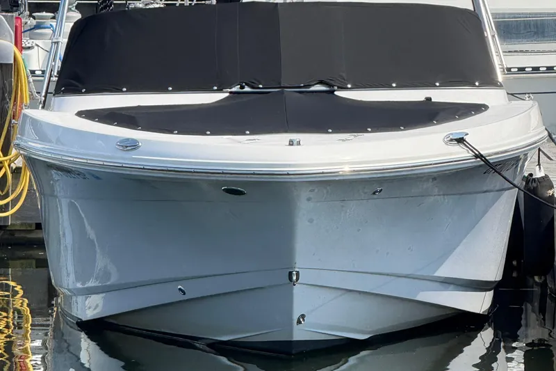 Slide: The Image of 2023 Robalo R207 Dual Console boat docked, featuring sleek design and black cover. - 9