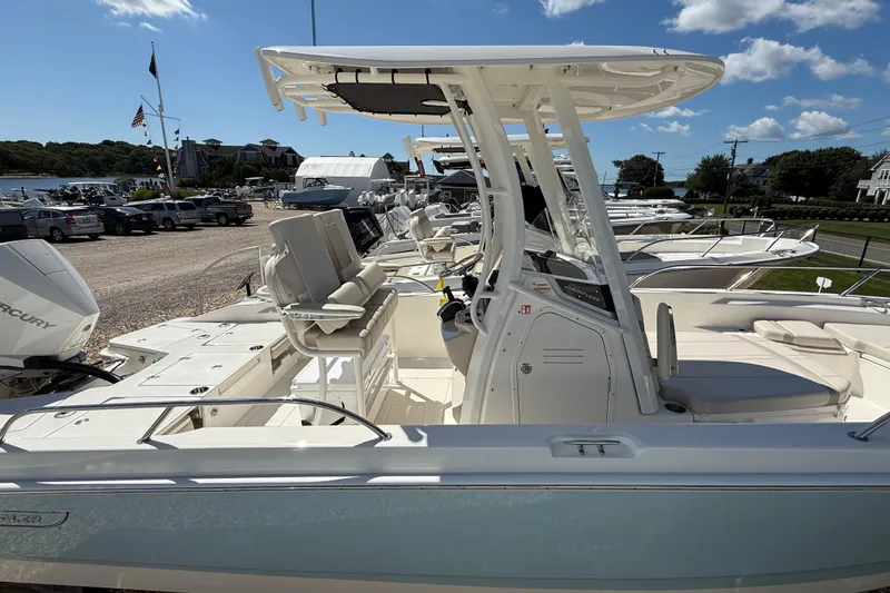 Slide: The Image of 2026 Boston Whaler 250 Dauntless boat, docked with clear skies and marina background. - 14