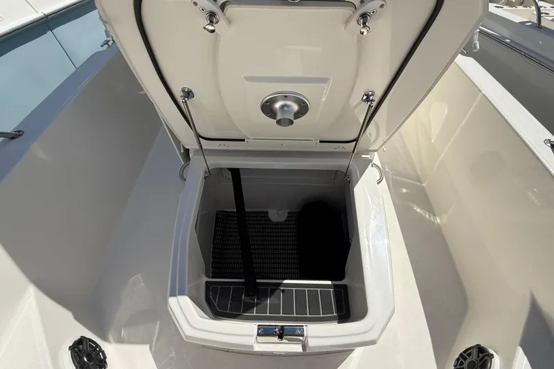 Slide: The Image of 2026 Boston Whaler 250 Dauntless storage compartment open, showcasing interior features. - 17