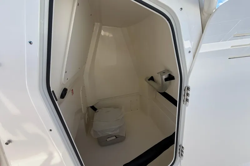 Slide: The Image of Interior of 2026 Boston Whaler 250 Dauntless boat's compact restroom space. - 19
