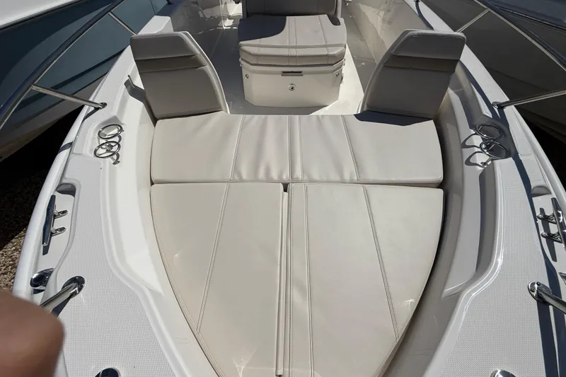 Slide: The Image of 2026 Boston Whaler 250 Dauntless boat interior with cushioned seating and cup holders. - 23