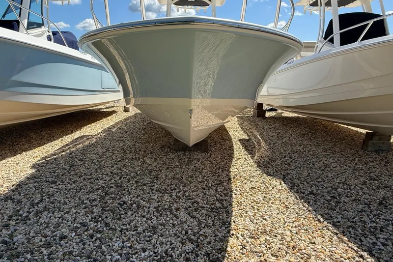 Slide: The Image of 2026 Boston Whaler 250 Dauntless boat on gravel, viewed from the front. - 27