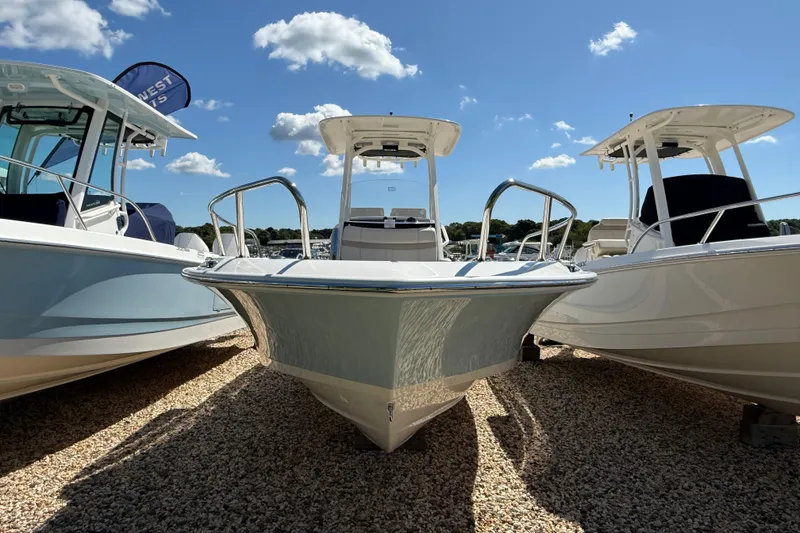 Slide: The Image of 2026 Boston Whaler 250 Dauntless boat displayed outdoors under a clear blue sky. - 28