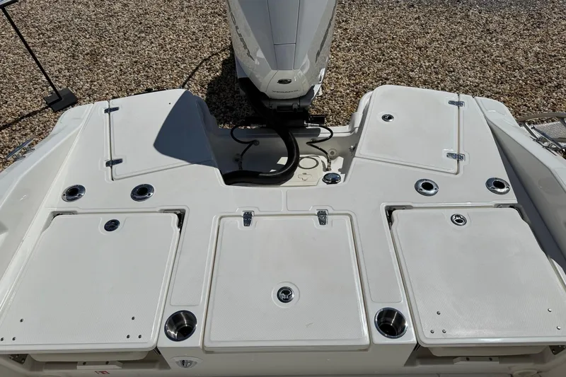 Slide: The Image of 2026 Boston Whaler 250 Dauntless boat deck with storage compartments and engine view. - 6
