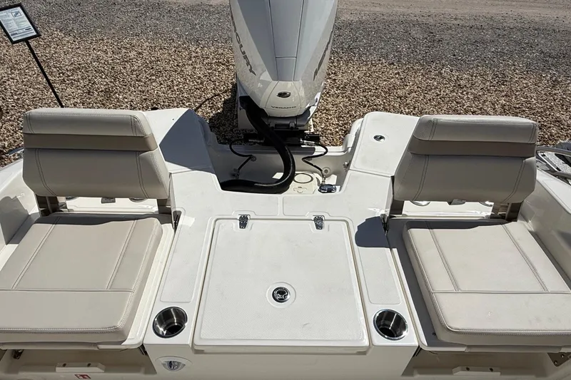Slide: The Image of 2026 Boston Whaler 250 Dauntless boat interior with cushioned seating and engine view. - 7