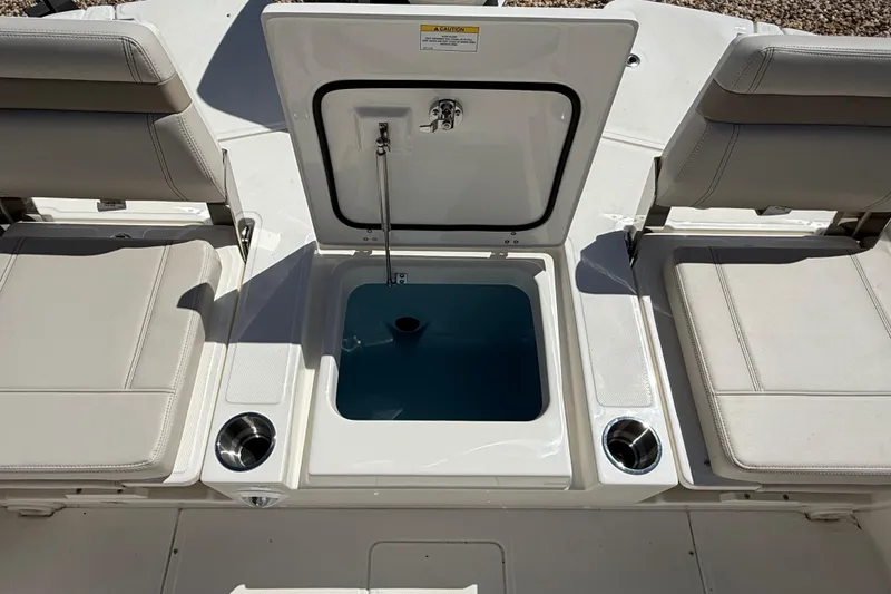 Slide: The Image of 2026 Boston Whaler 250 Dauntless boat seating area with storage compartment open. - 8