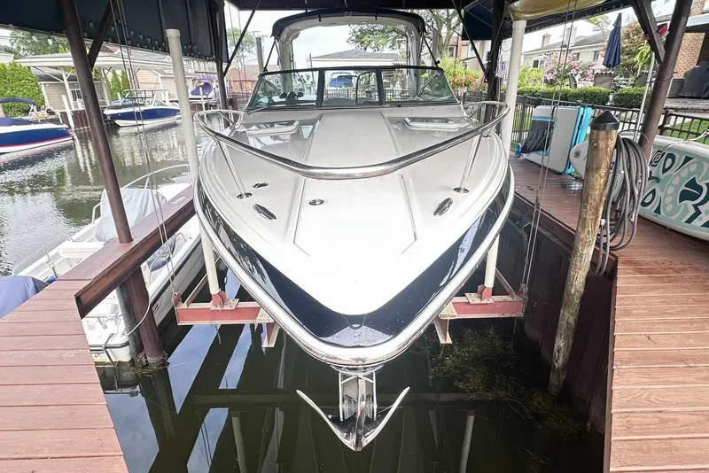Slide: The Image of 2007 Formula 310 Sun Sport boat docked in a marina, front view. - 1