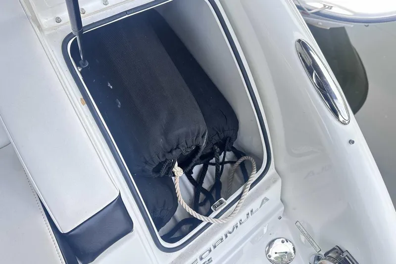 Slide: The Image of Storage compartment on a 2007 Formula 310 Sun Sport boat with black fenders and rope. - 13