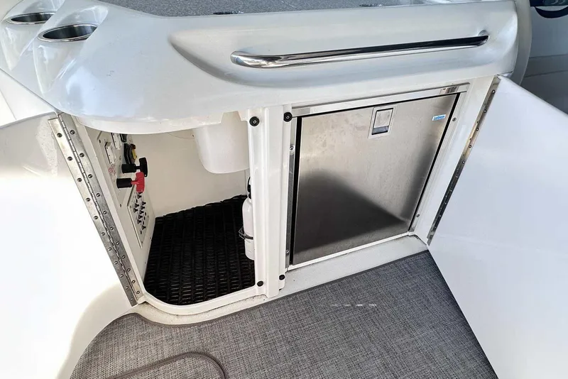 Slide: The Image of 2007 Formula 310 Sun Sport boat interior with storage and stainless steel fridge. - 18
