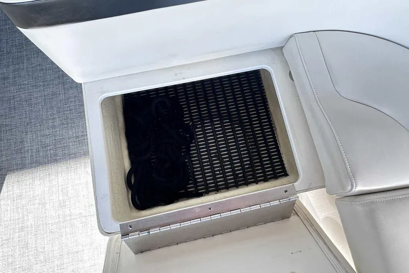 Slide: The Image of Storage compartment on a 2007 Formula 310 Sun Sport boat with black rope inside. - 22