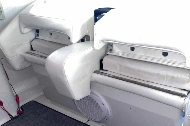 Slide: The Image of Interior seating of a 2007 Formula 310 Sun Sport boat, featuring white cushioned seats. - 26