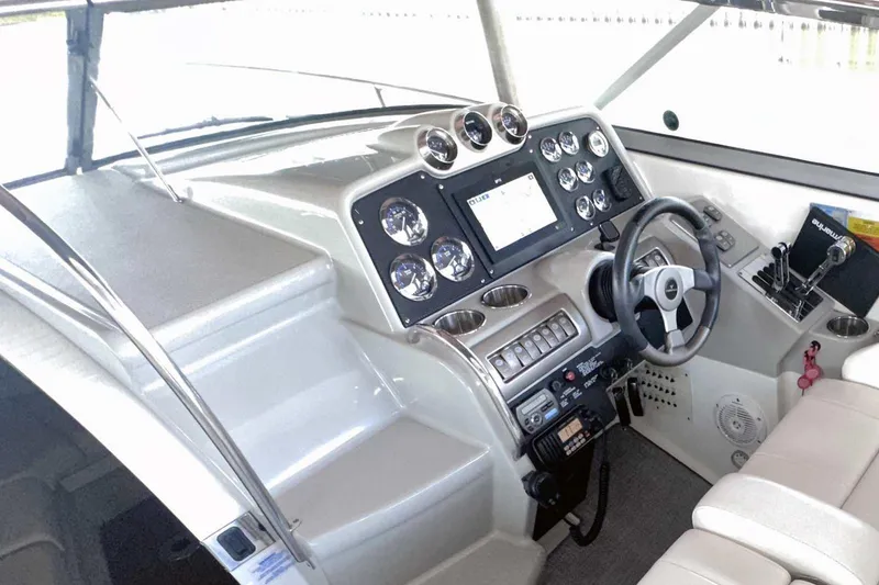 Slide: The Image of 2007 Formula 310 Sun Sport boat cockpit with steering wheel and control panel. - 27