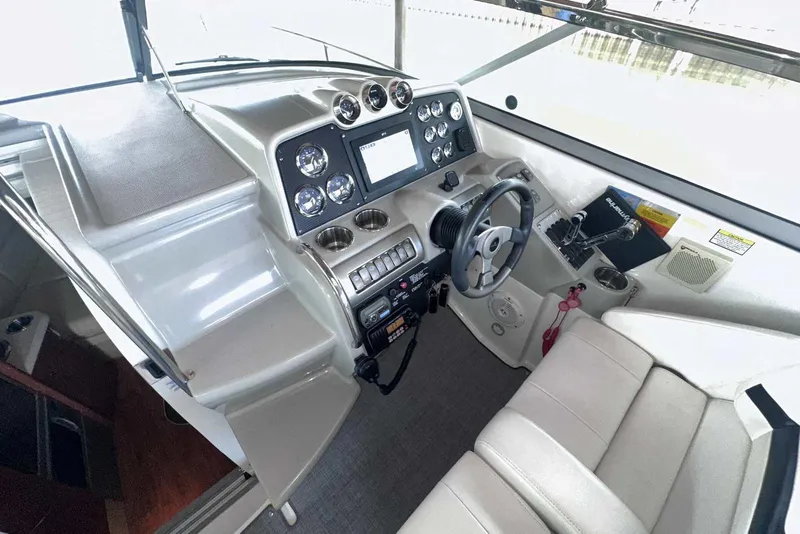 Slide: The Image of 2007 Formula 310 Sun Sport boat cockpit with steering wheel and control panel. - 29