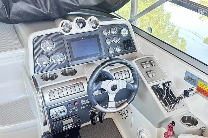 Slide: The Image of 2007 Formula 310 Sun Sport boat dashboard with steering wheel, gauges, and control panel. - 30