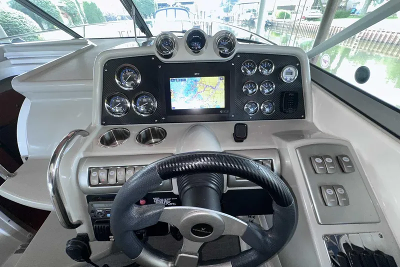 Slide: The Image of 2007 Formula 310 Sun Sport dashboard with steering wheel, gauges, and navigation screen. - 31