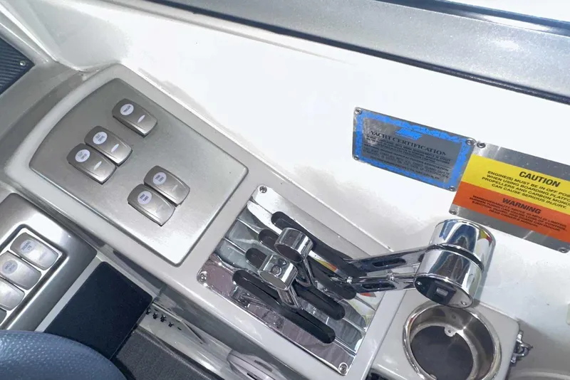 Slide: The Image of Control panel of a 2007 Formula 310 Sun Sport boat with switches and throttle levers. - 32