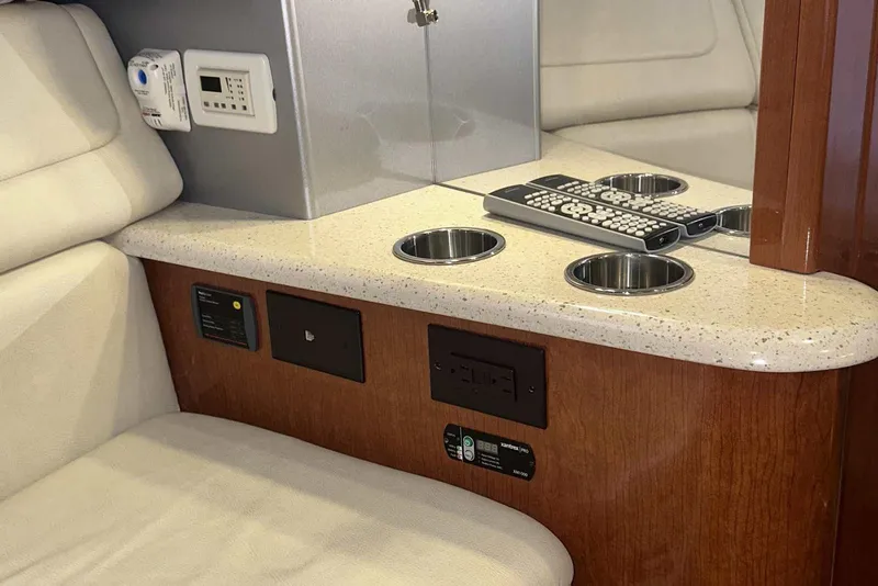 Slide: The Image of 2007 Formula 310 Sun Sport interior with cup holders and remote controls on a countertop. - 41