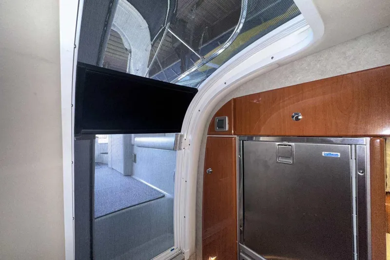 Slide: The Image of Interior of 2007 Formula 310 Sun Sport boat with wood paneling and compact fridge. - 46