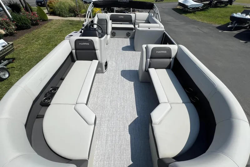 Slide: The Image of 2025 Harris Cruiser 230 pontoon boat with spacious seating and modern design. - 10