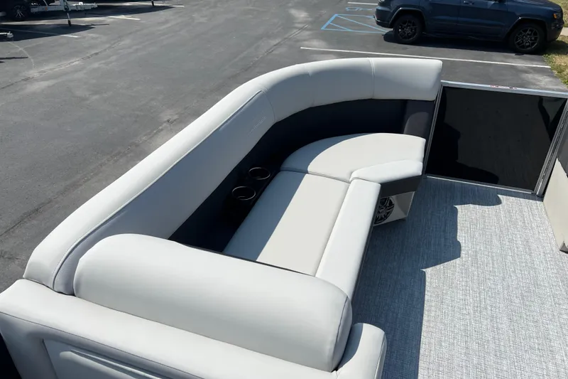 Slide: The Image of 2025 Harris Cruiser 230 boat interior with plush seating and cup holders. - 11