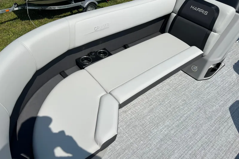 Slide: The Image of 2025 Harris Cruiser 230 boat interior with cushioned seating and cup holders. - 12