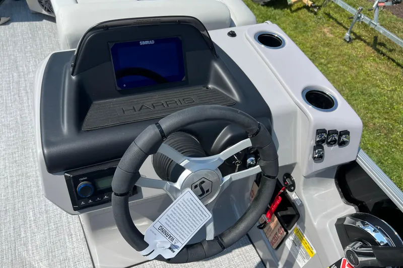 Slide: The Image of Steering console of 2025 Harris Cruiser 230 boat with Simrad display and controls. - 14