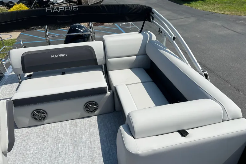 Slide: The Image of 2025 Harris Cruiser 230 boat interior with plush seating and integrated speakers. - 18