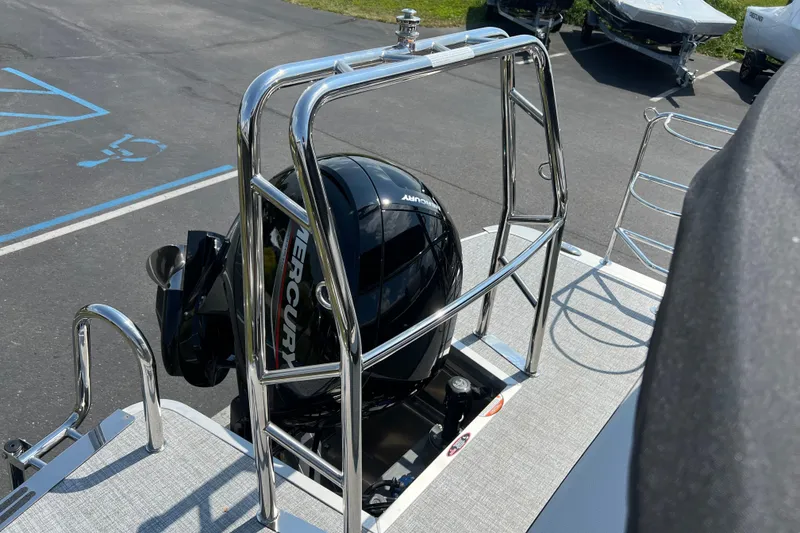 Slide: The Image of 2025 Harris Cruiser 230 boat with Mercury engine, parked on asphalt. - 22