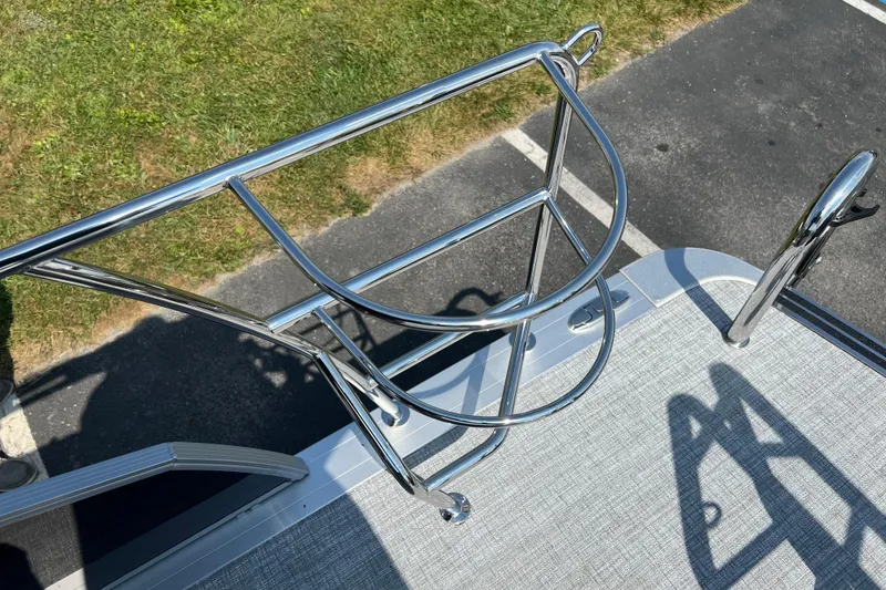 Slide: The Image of Stainless steel railing on 2025 Harris Cruiser 230 boat deck, with grass and pavement background. - 23