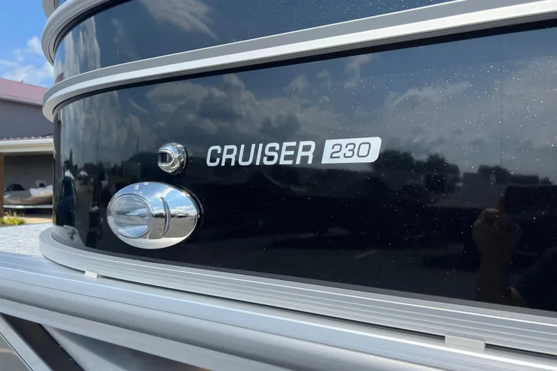 Slide: The Image of 2025 Harris Cruiser 230 boat exterior with sleek black finish and chrome details. - 3