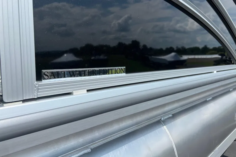 Slide: The Image of 2025 Harris Cruiser 230 Saltwater Edition, close-up of sleek metallic exterior. - 4