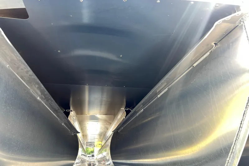 Slide: The Image of Underneath view of 2025 Harris Cruiser 230 boat, showcasing sleek metallic structure. - 6