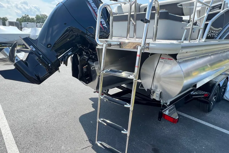 Slide: The Image of 2025 Harris Cruiser 230 pontoon boat with Mercury outboard motor and boarding ladder. - 8