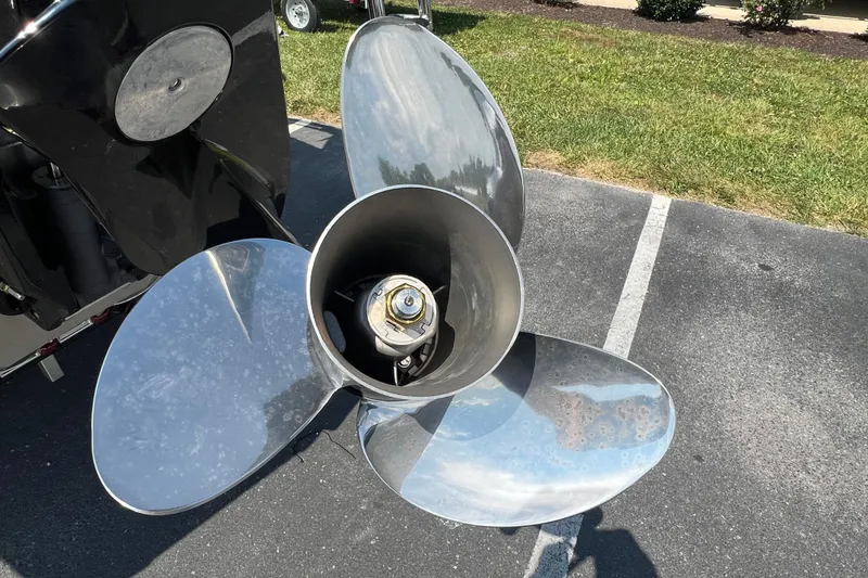 Slide: The Image of Close-up of a 2025 Harris Cruiser 230 boat propeller on pavement. - 9