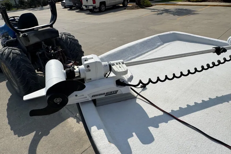 Slide: The Image of 1998 Coastal Skiff 19 with Minn Kota trolling motor on a trailer. - 11