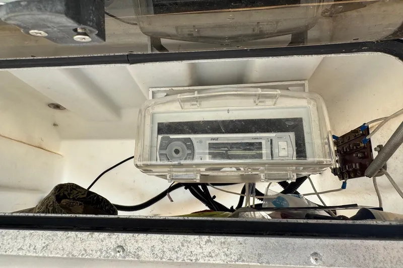 Slide: The Image of 1998 Coastal Skiff 19 boat interior with Pyle stereo system in protective casing. - 13