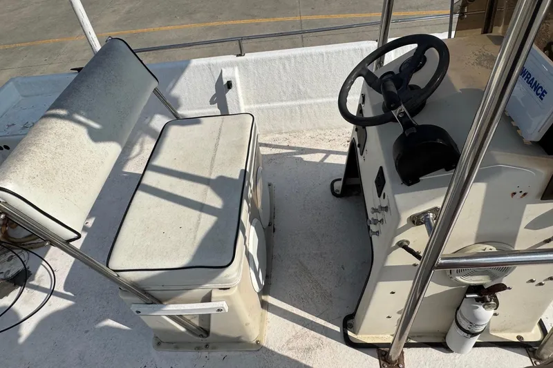 Slide: The Image of Interior of a 1998 Coastal Skiff 19 boat showing seating and steering console. - 8