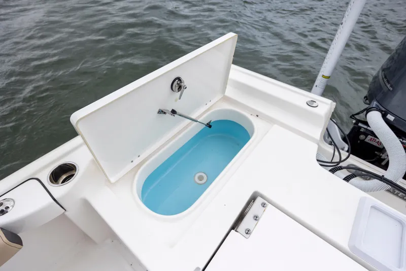Slide: The Image of 2022 Tidewater 2300 Carolina Bay boat with open livewell on deck. - 24
