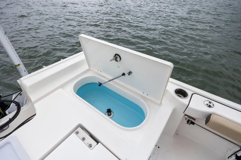 Slide: The Image of 2022 Tidewater 2300 Carolina Bay boat with open livewell on deck. - 25