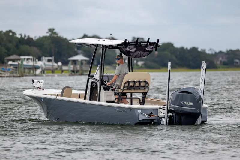 Slide: The Image of 2022 Tidewater 2300 Carolina Bay boat cruising on a calm lake with Yamaha engine. - 4
