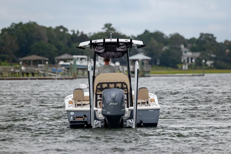 Slide: The Image of 2022 Tidewater 2300 Carolina Bay boat on water, rear view with Yamaha engine. - 5