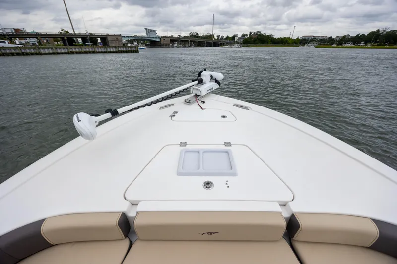 Slide: The Image of 2022 Tidewater 2300 Carolina Bay boat on water, featuring spacious deck and trolling motor. - 8