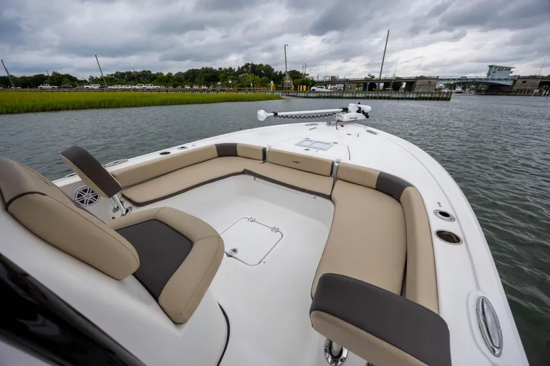 Slide: The Image of 2022 Tidewater 2300 Carolina Bay boat with spacious seating on a calm waterway. - 9