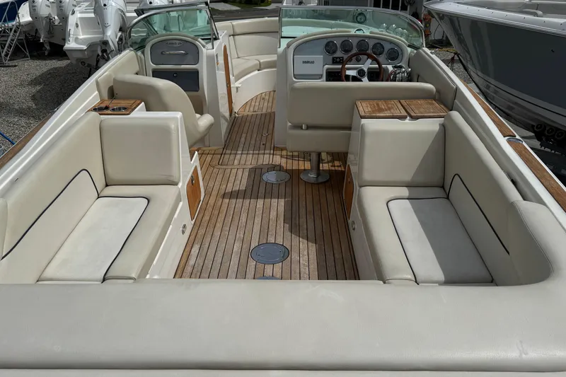 Slide: The Image of 2007 Chris-Craft Launch 28 boat interior with beige seating and wooden flooring. - 10