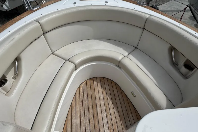 Slide: The Image of 2007 Chris-Craft Launch 28 boat interior with beige seating and wooden flooring. - 12