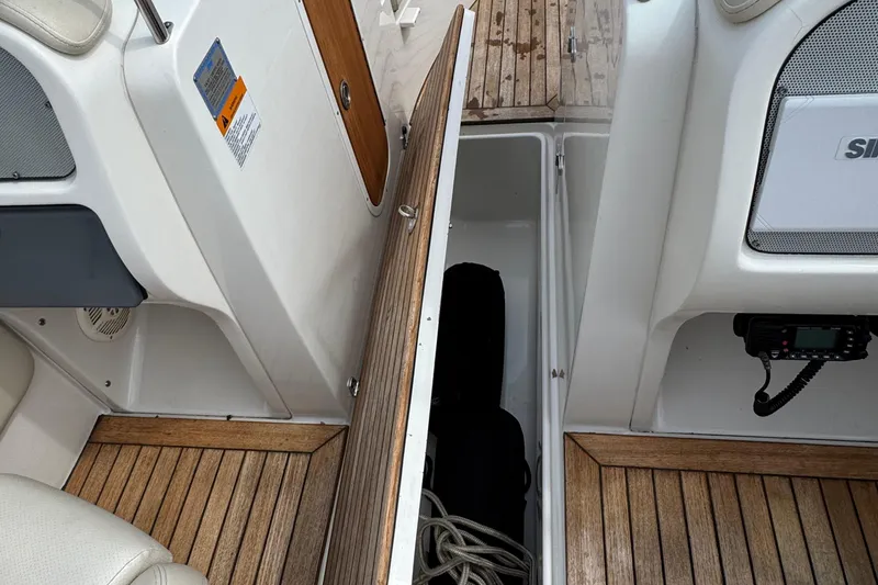 Slide: The Image of 2007 Chris-Craft Launch 28 interior storage compartment with wooden flooring and seating. - 18