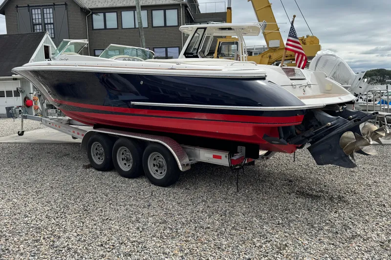 Slide: The Image of 2007 Chris-Craft Launch 28 boat on trailer, displayed outdoors near buildings. - 3