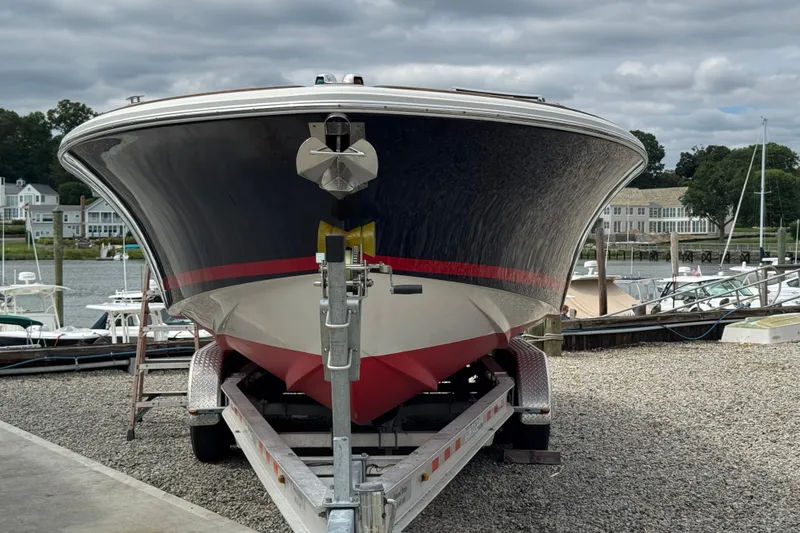 Slide: The Image of 2007 Chris-Craft Launch 28 boat on trailer at marina, cloudy sky background. - 8