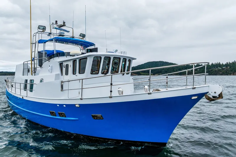 Slide: The Image of 1978 Hidden Harbor Custom Trawler cruising on open water under cloudy skies. - 13